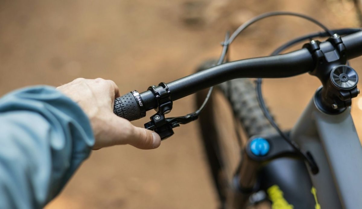 a close up of a person's hand on the handlebars of a cycle                         