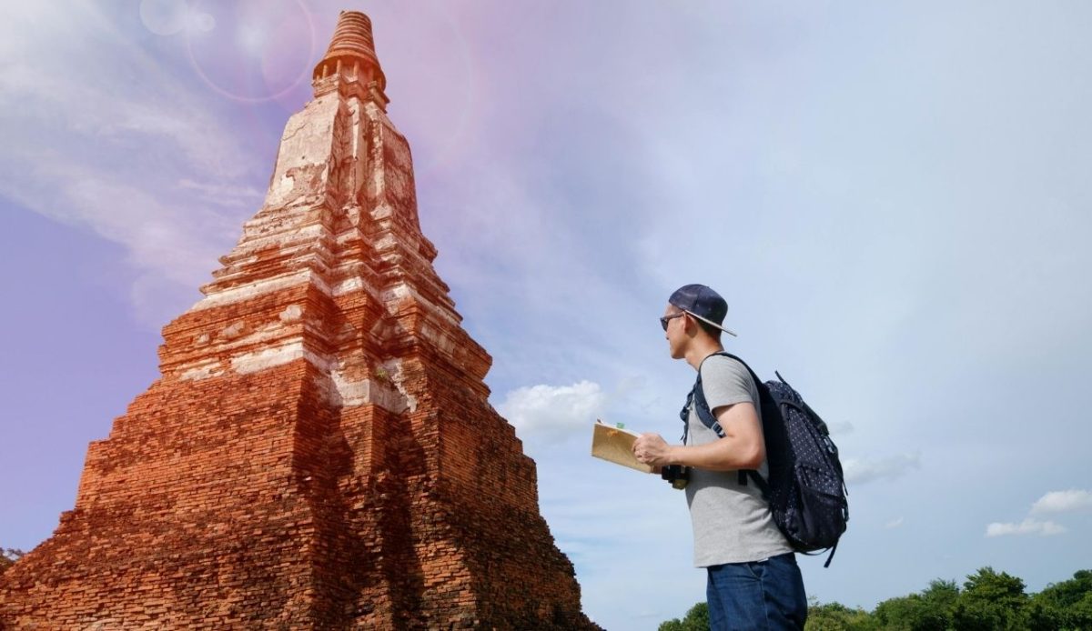 male traveler wearing simple dress visiting tomb structure                 