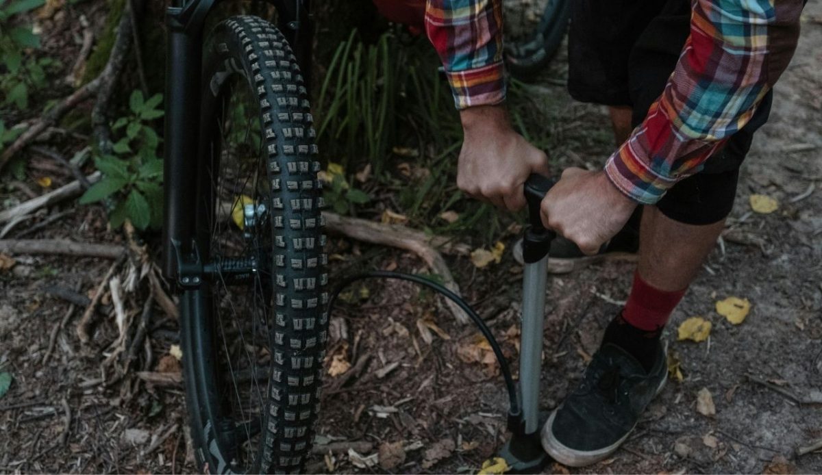 man pumping bicycle tire                    
