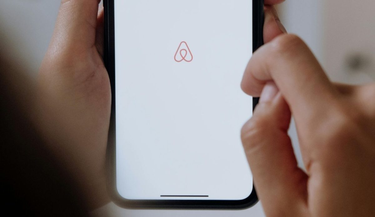 Airbnb app icon displayed on cell phone     