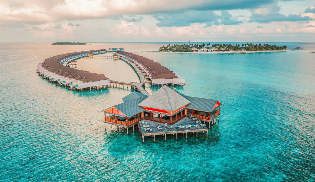 Overwater bungalows in the Maldives surrounded by turquoise clear water 