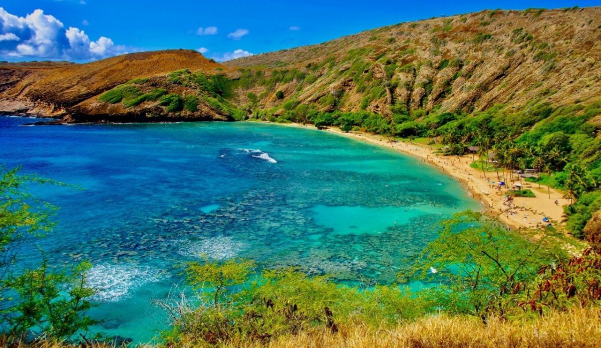 Hanauma Bay, Oahu, Hawaii, with clear waters and sandy beach surrounded by hills 