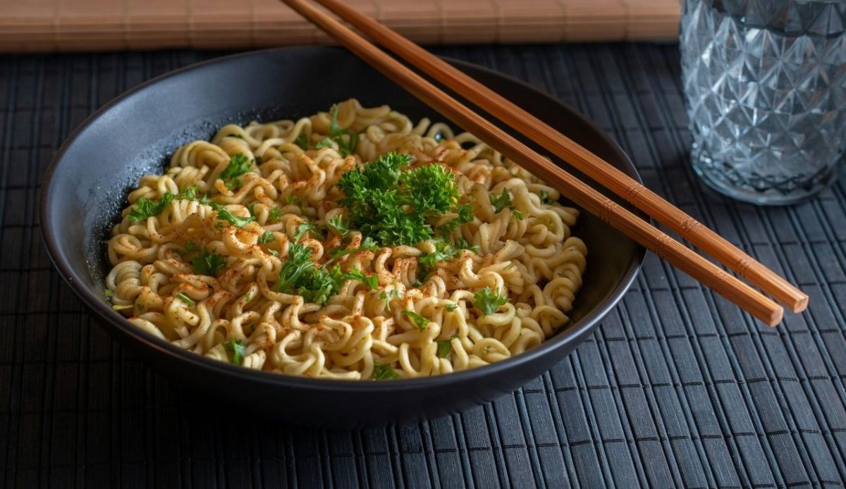 Bowl of Spicy Instant Noodles with Chopsticks                          