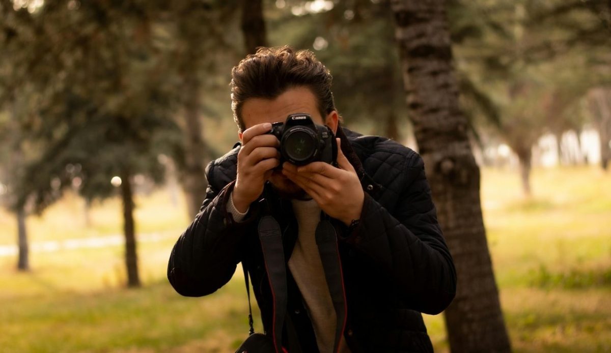 Man Taking a Photo Using Black Dslr Camera                       