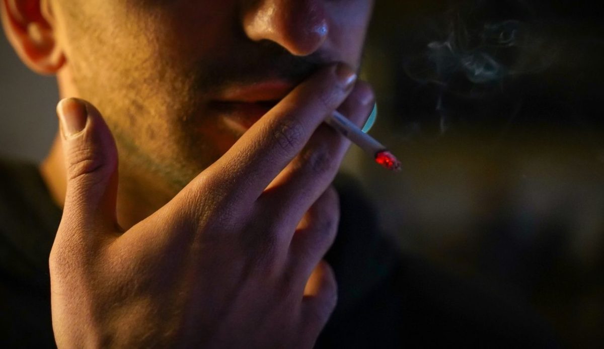 Man smoking a cigarette at night