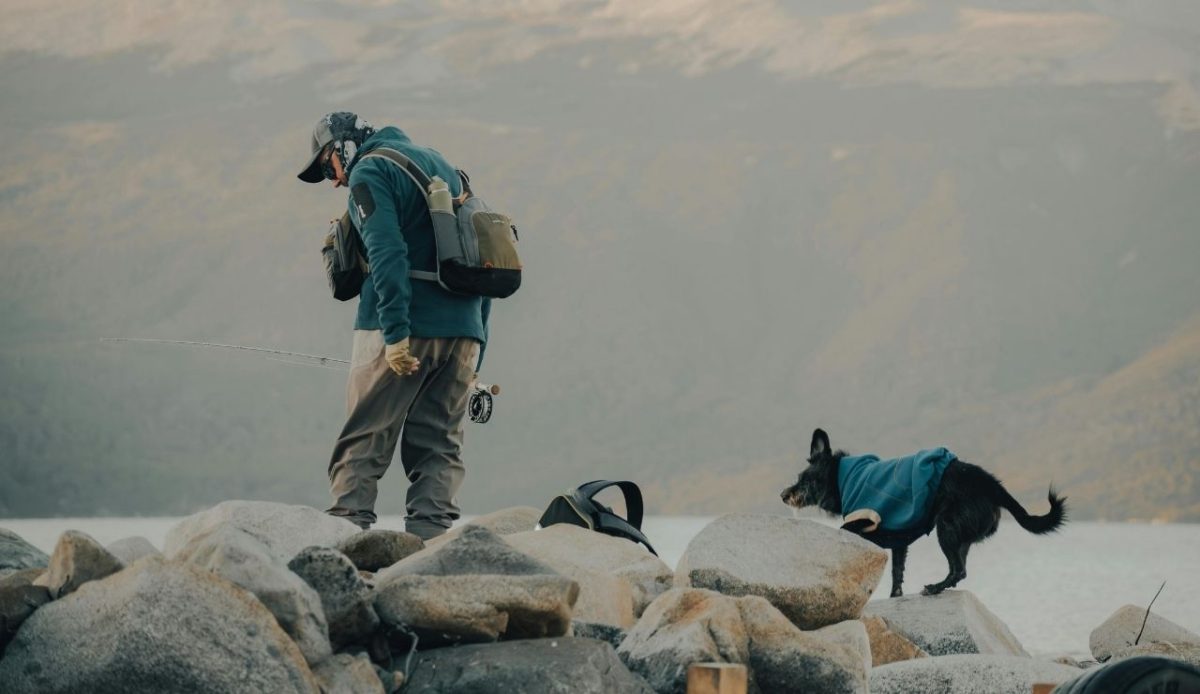 12 Seasonal Hiking Goals to Make 2026 Your Best Outdoor Year Yet 11 Man with Backpack Hiking with Dog on Lakeshore