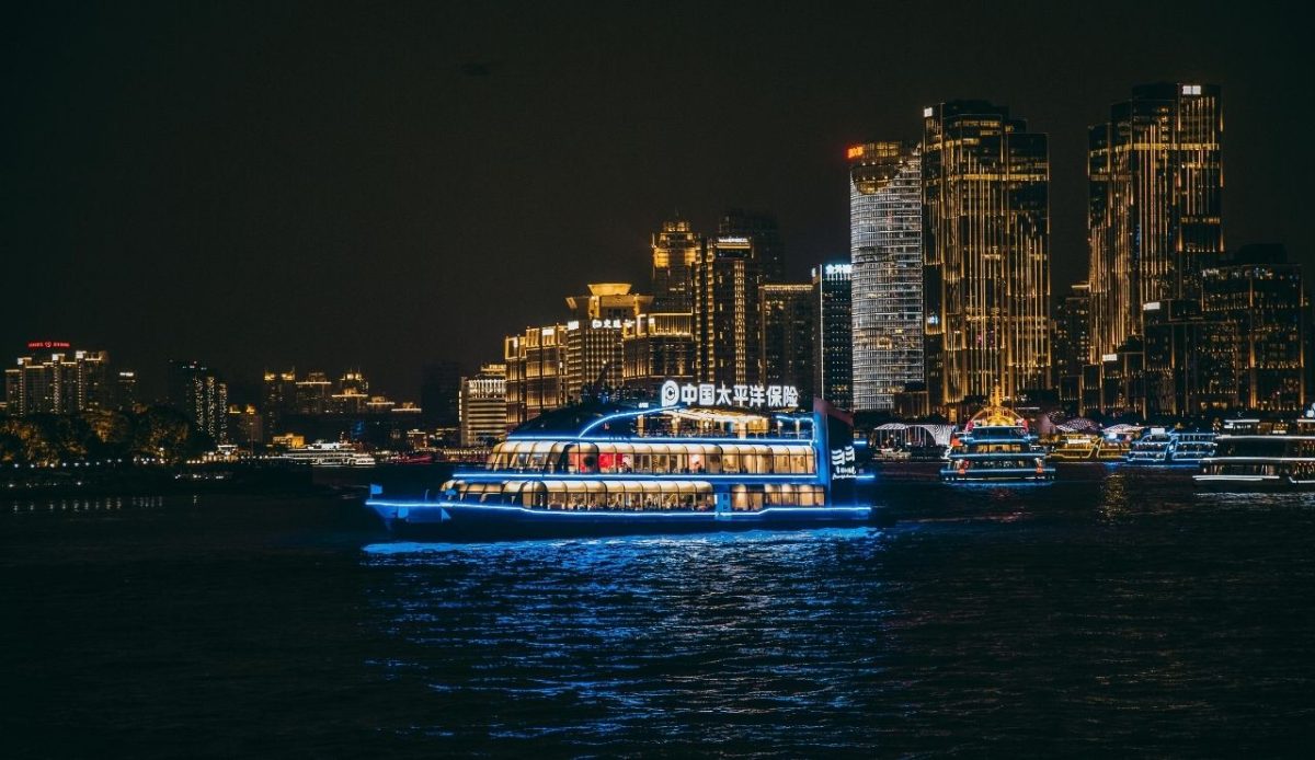 Nighttime Skyline with Illuminated Cruise Ship                                   