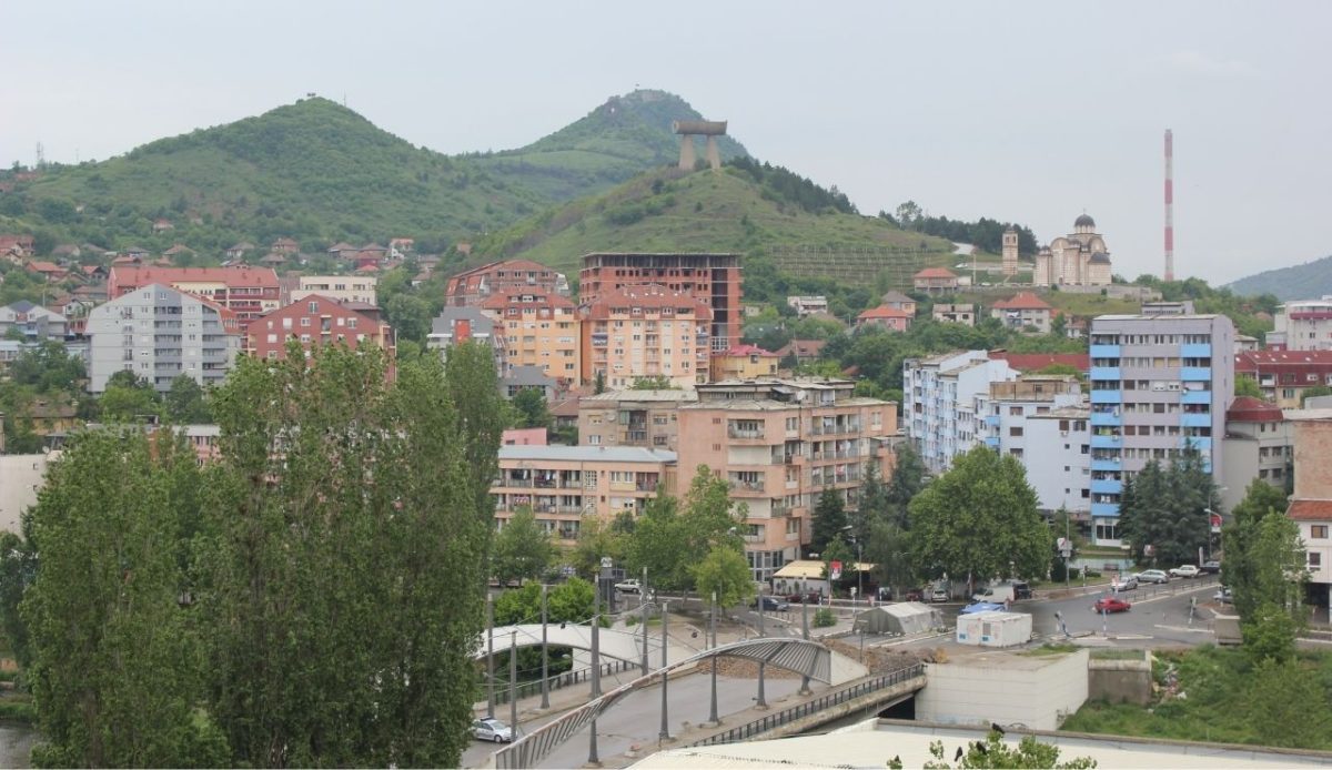 North Mitrovica; Zvečan Fortress on the mountain to the left, Trepča chimney on the right, and Ibar Bridge in the center.                         