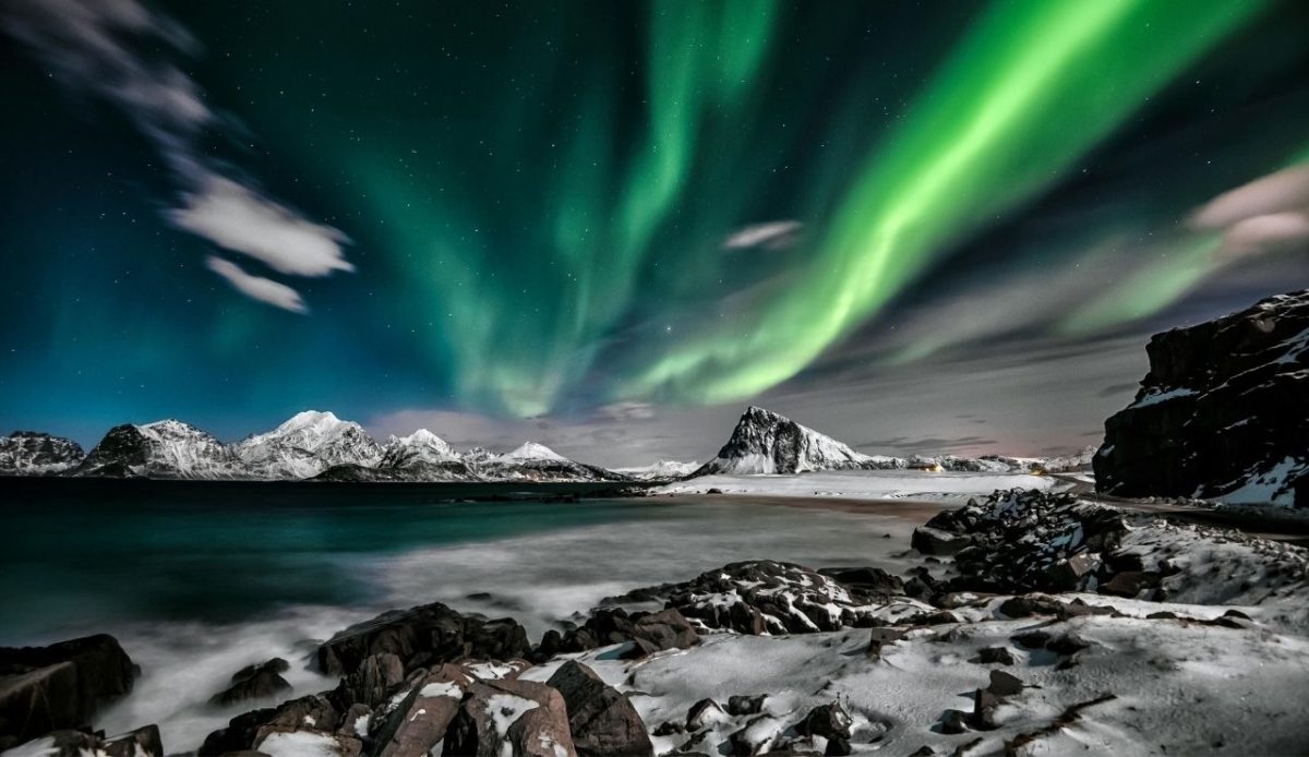 Northern Lights over snowy coast, Lofoten Islands, Norway