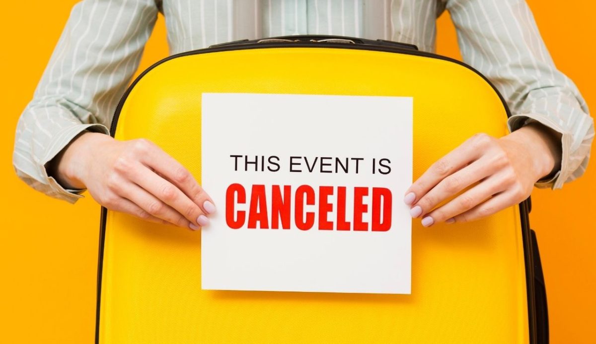 Woman holding a cancelled event card   