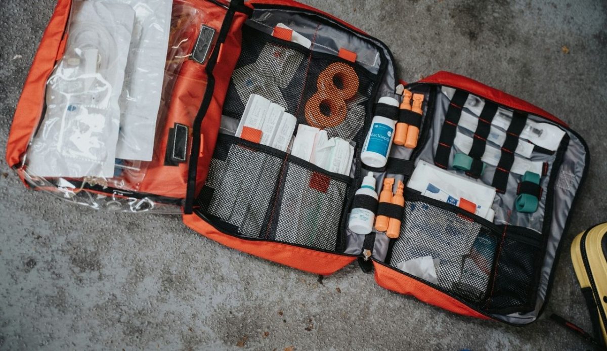 a bulky first aid kit bag contains mutliple first aid things                           