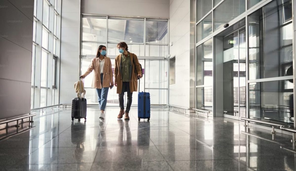 a couple walk through airport lounge                      