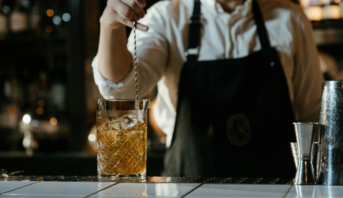 a man is mixing in alcohol                