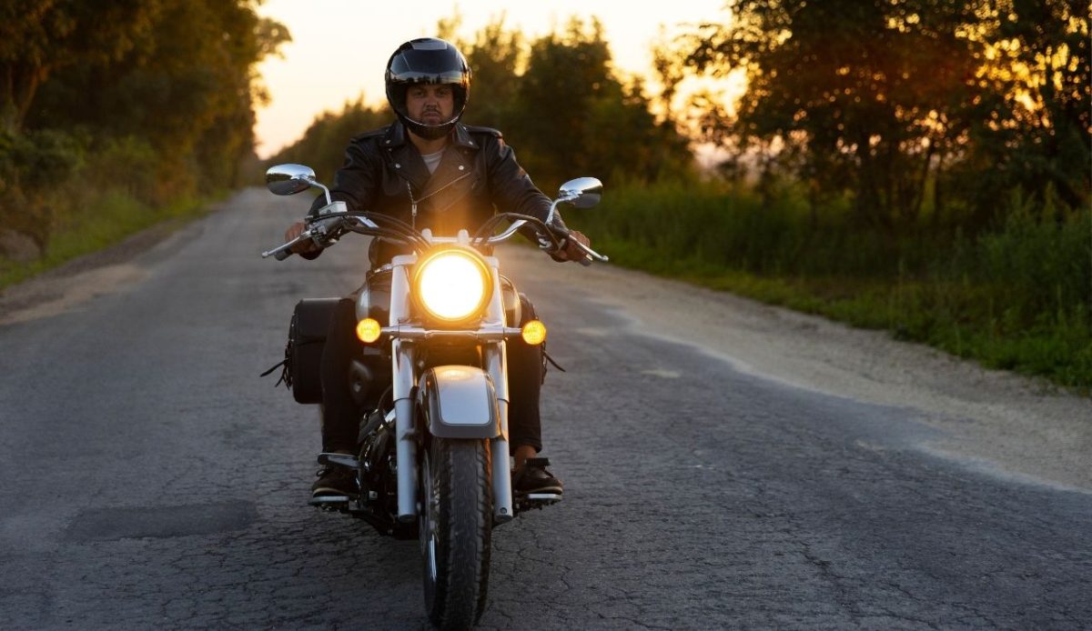 a motorcyclist with headlight on                          