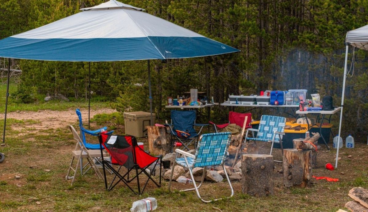 camp chairs setups around camp fire                         