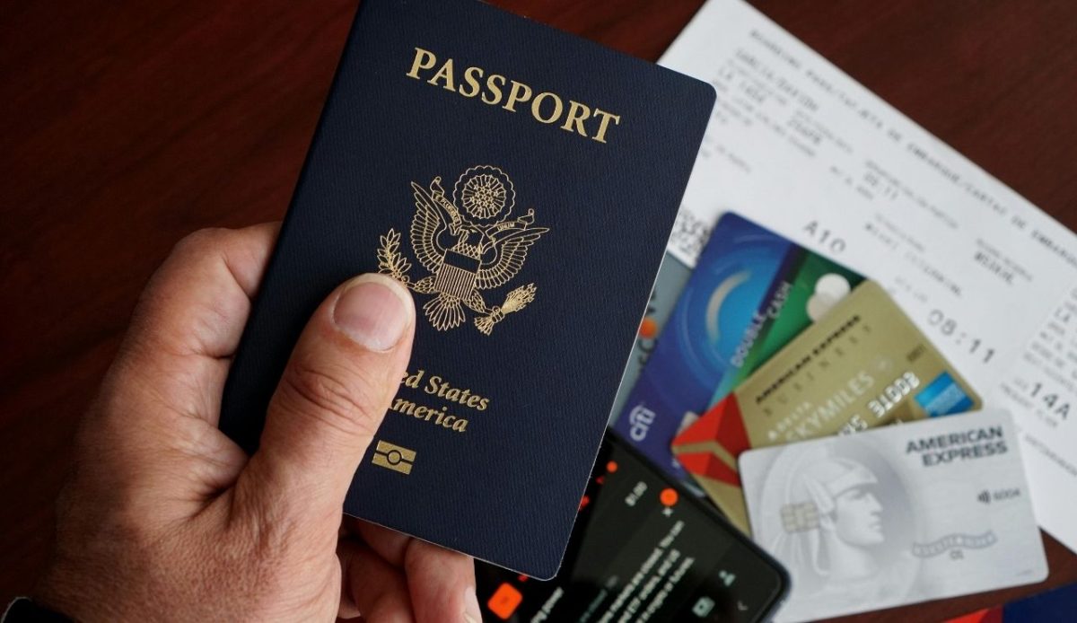 Close-up of US passport with travel essentials    
