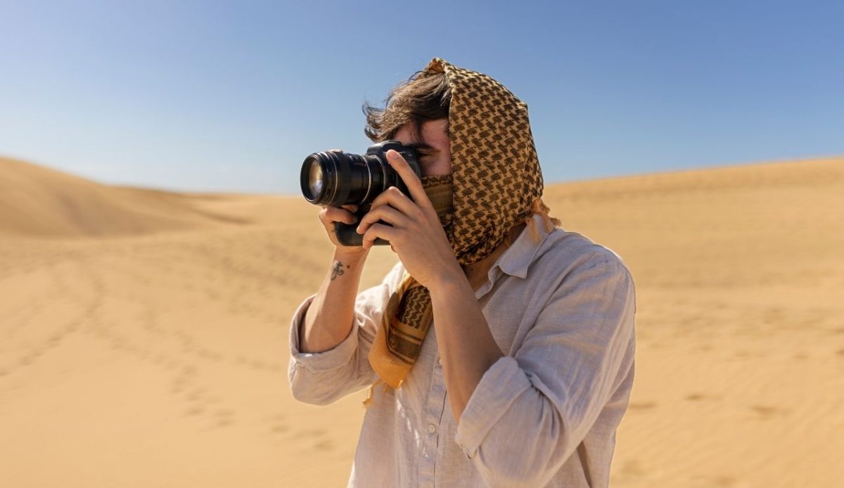 Side view man taking photos with camera                         