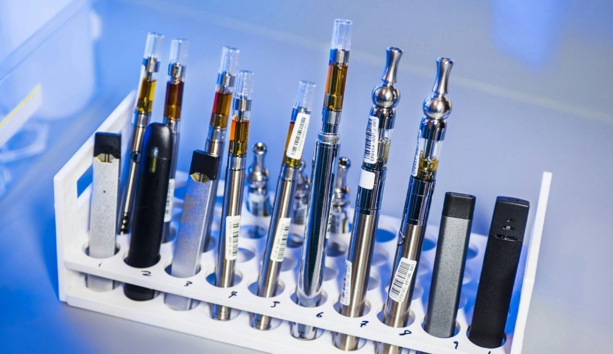 electronic cigarettes or e-cigarettes placed in a test tube rack                      