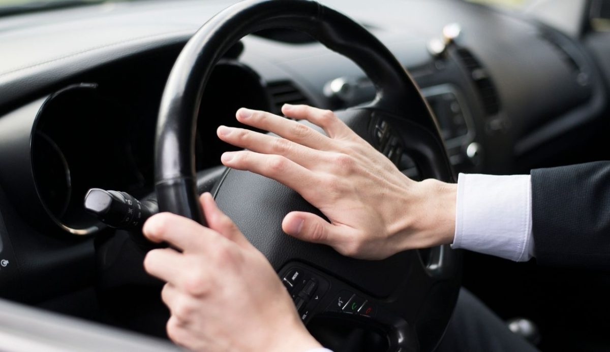 man pressing car Horn                    