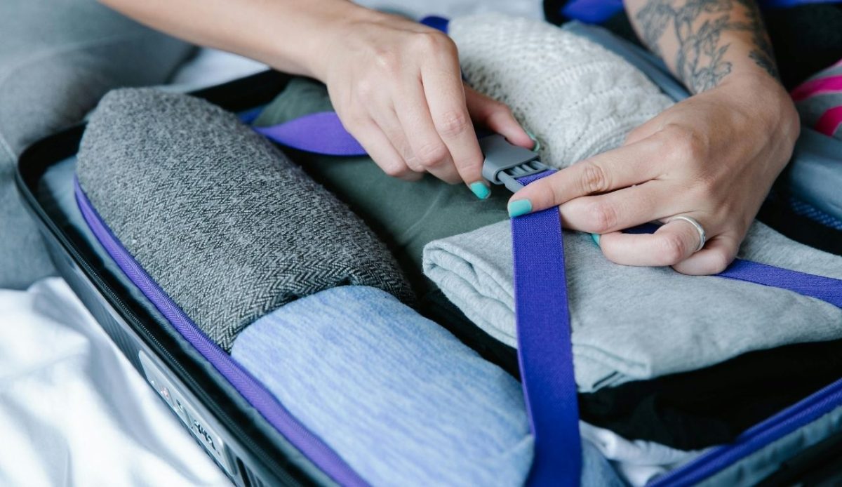 packing cloths in suitcase                             