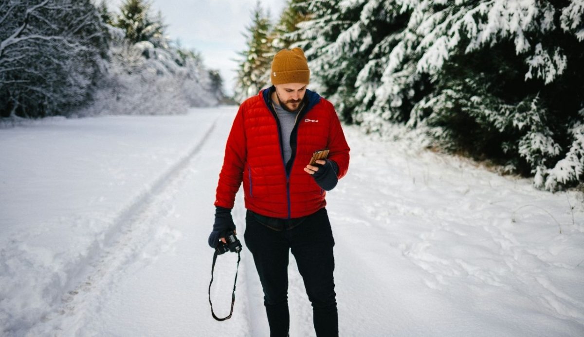 12 Seasonal Hiking Goals to Make 2026 Your Best Outdoor Year Yet 1 photo of man holding camera in winter