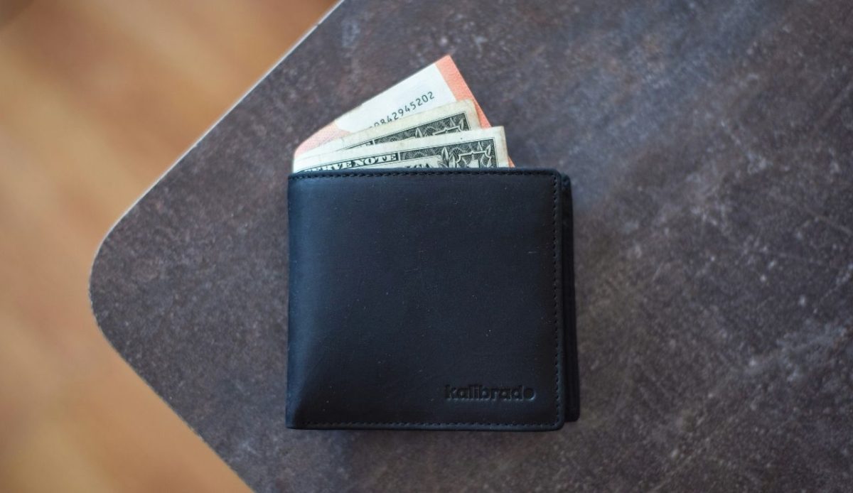 wallet with currency left on table                           