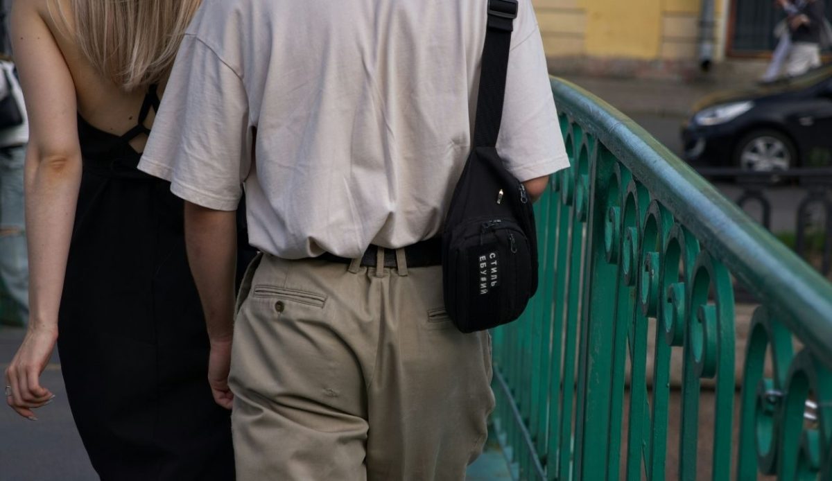 woman wears backpack in crowd                      