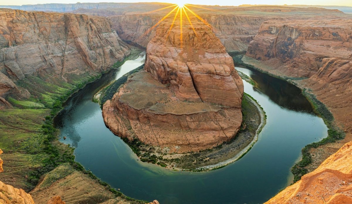 Arizona Horseshoe Bend with the Colorado River and sunburst over the canyon 