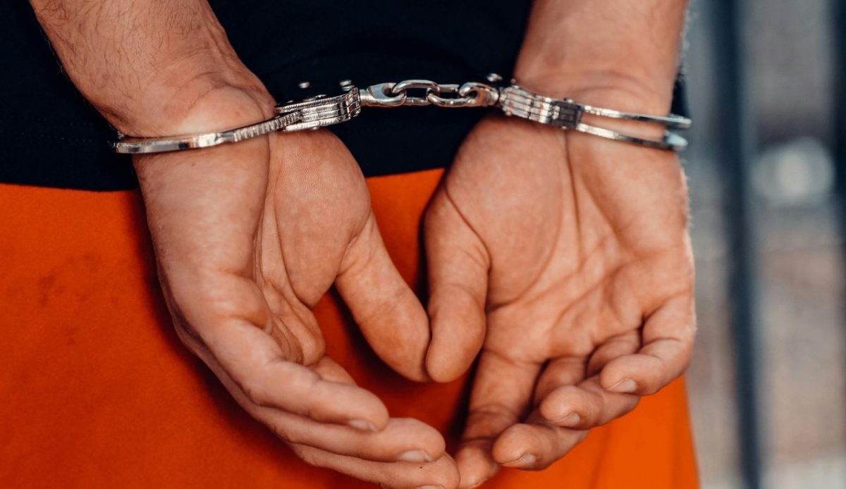 Close-Up Shot of a Person with Handcuffs      
