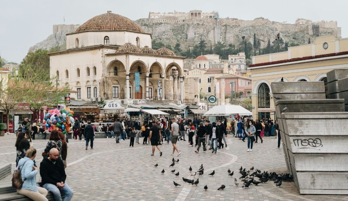 Crowds in Monastiraki Square with the Acropolis in Athens, Greece                     