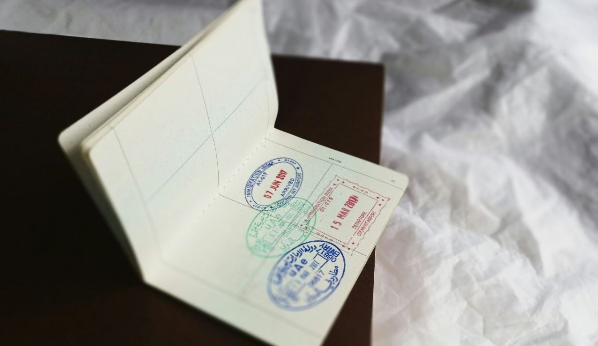 Open passport with entry and exit stamps
