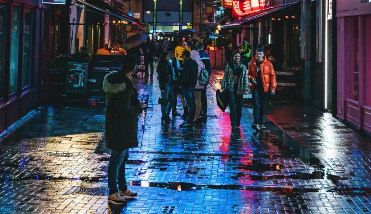 People Standing Between Buildings during Nighttime                                         Connor 