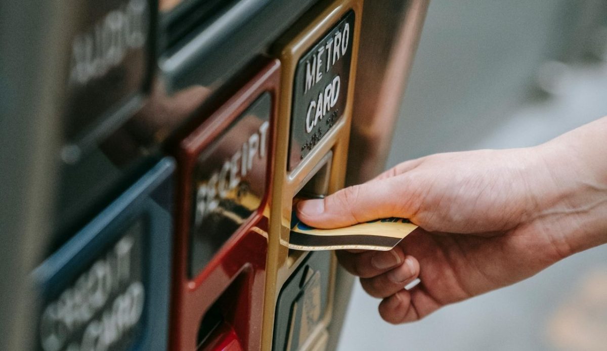 Person Purchasing Ticket from Vending Machine