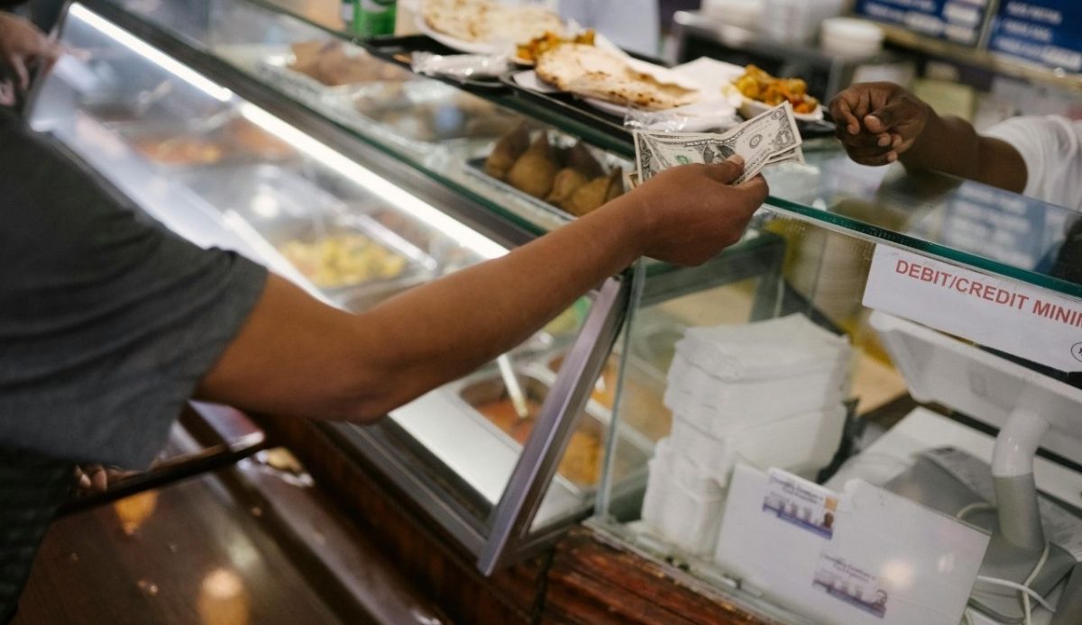 Person paying cash for food in cafe                                  