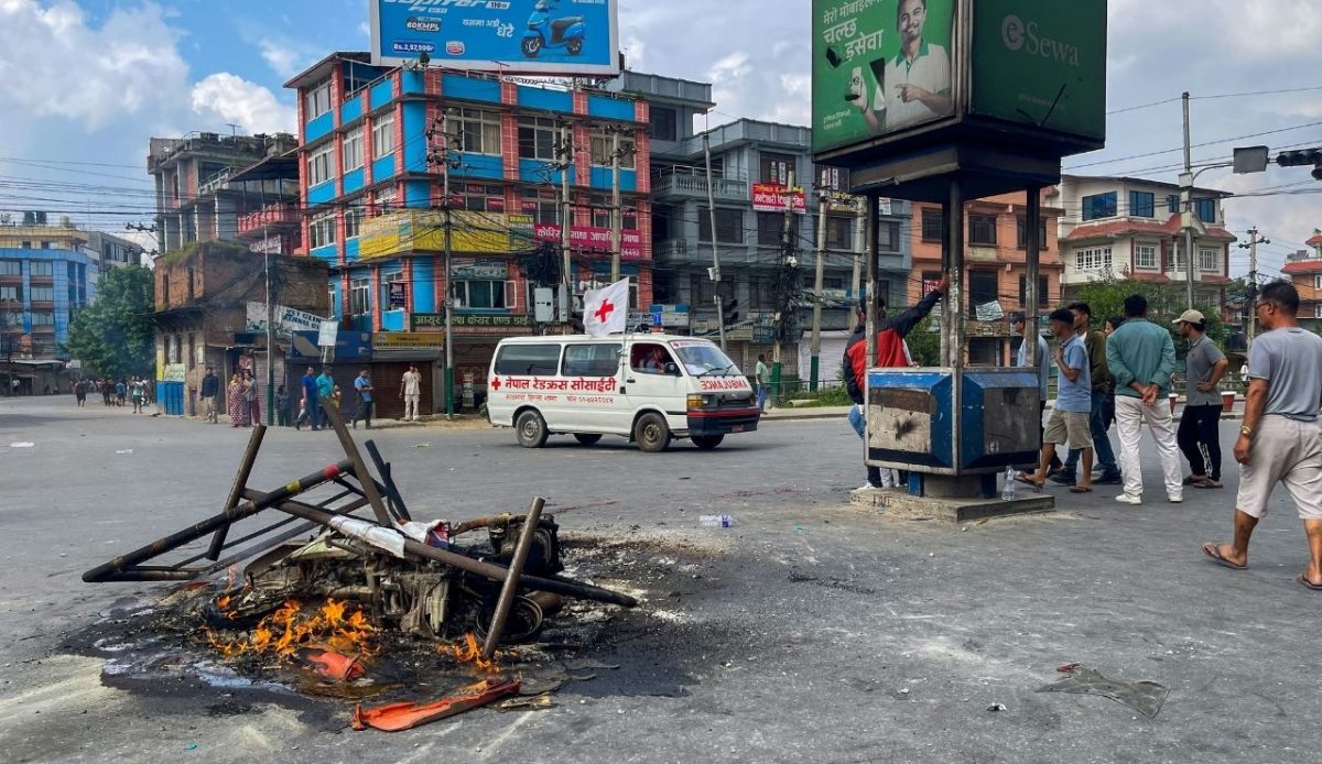 Protesters set fire to debris and barricades in the middle of a road in Nepal                             