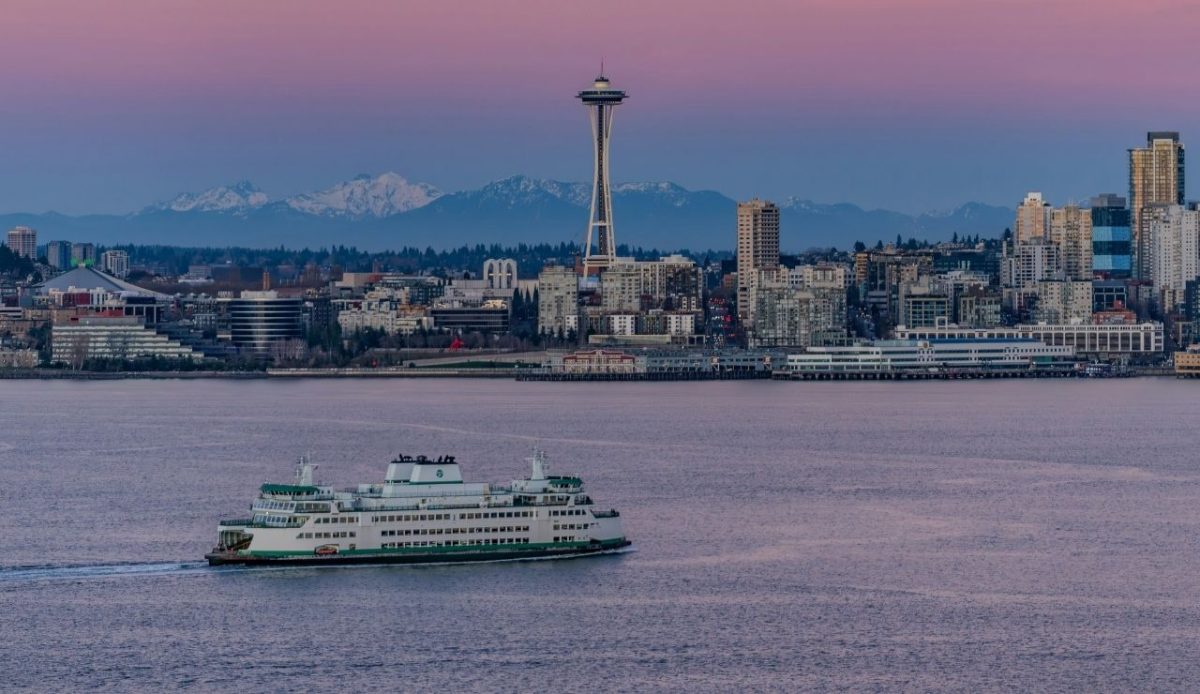 The Seattle skyline as a Washington State Ferry traverses across Elliot Bay.                               