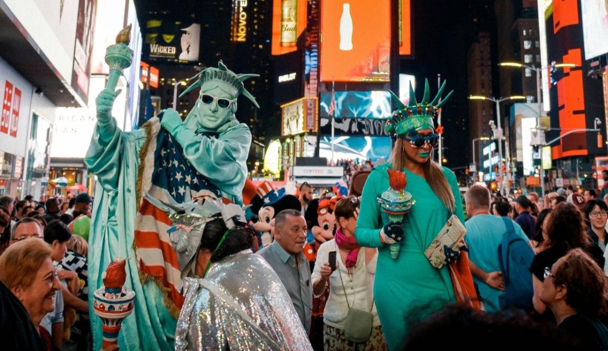 Two street performers dressed as the Statue of Liberty in Times Square, New York City,                                 