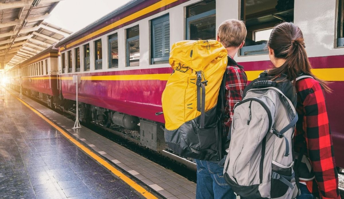 a couple is standing at train station                        