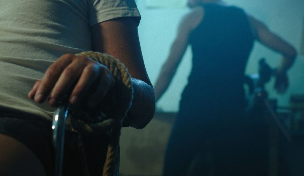 a man is handcuffed with rope seems kidnapped                                   