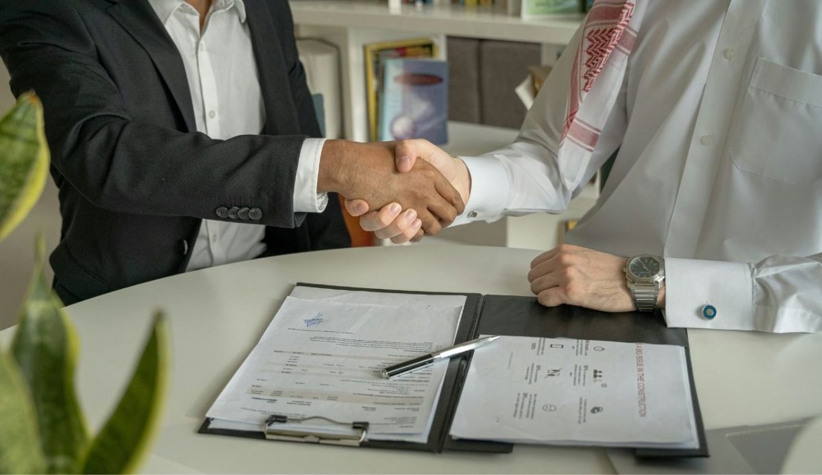 an arabic guy is shaking hand for job offer                            