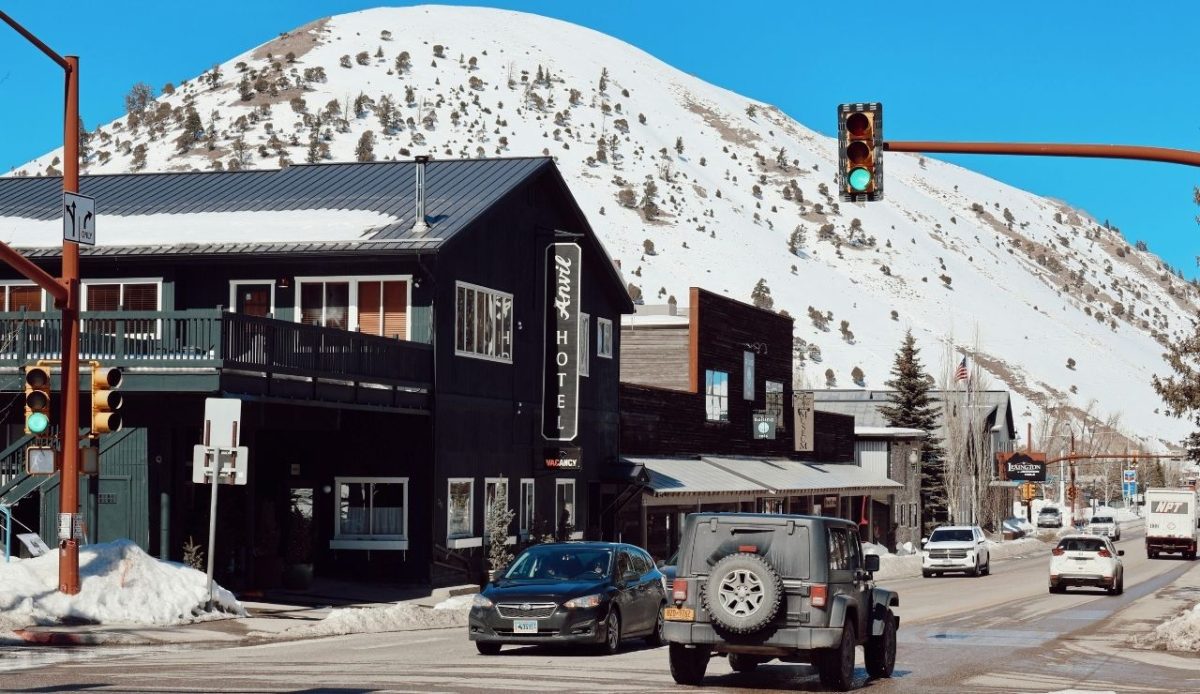 Snow-covered mountain town street with cars and hotel in Jackson Wyoming