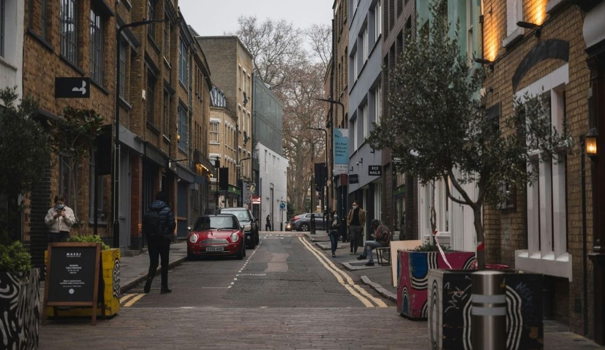 man standing in a less crowded street                                