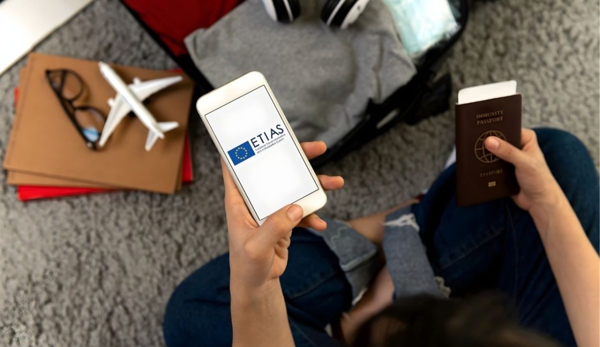 man with phone and passport in hand                           