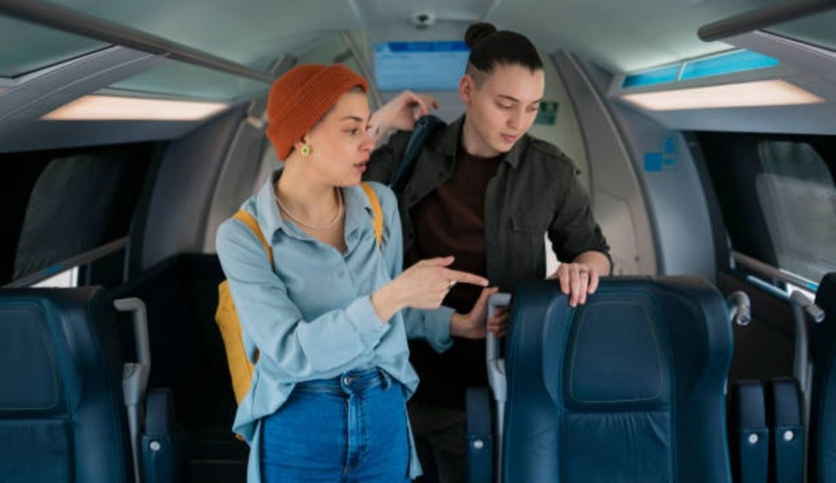passenger is pointing out towards seat                 
