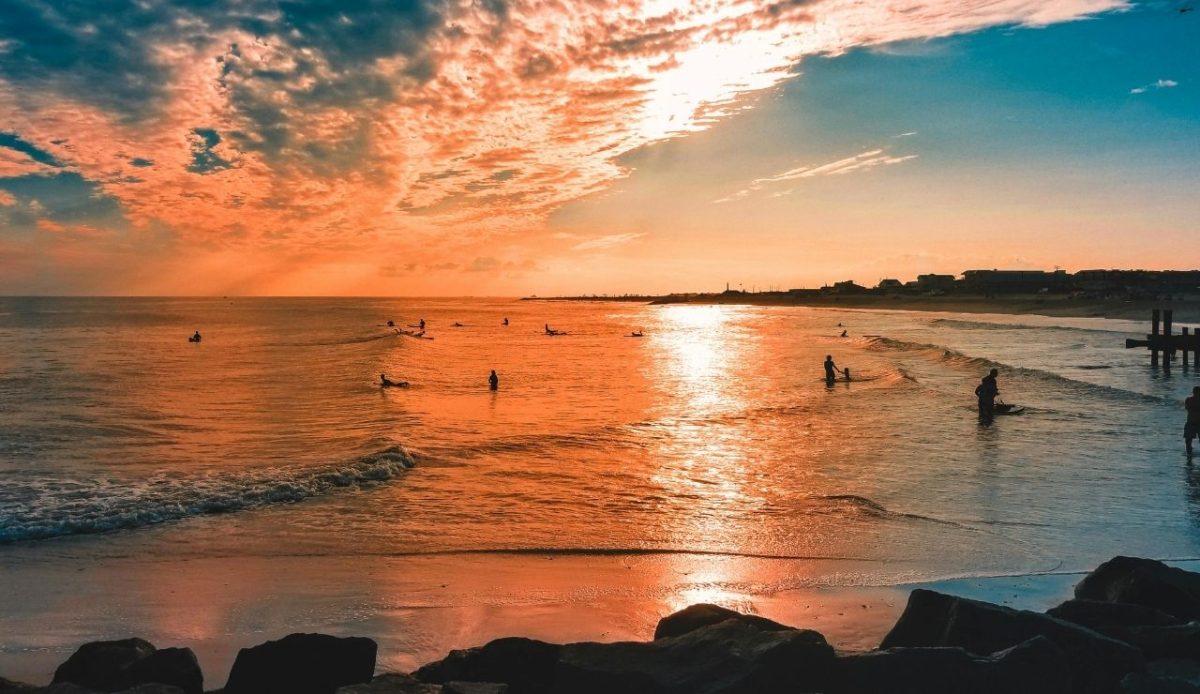 10 Coastal Vacation Markets Squeezed by Rising Insurance Costs 9 sunset surfers at Cape May Beach, New Jersey