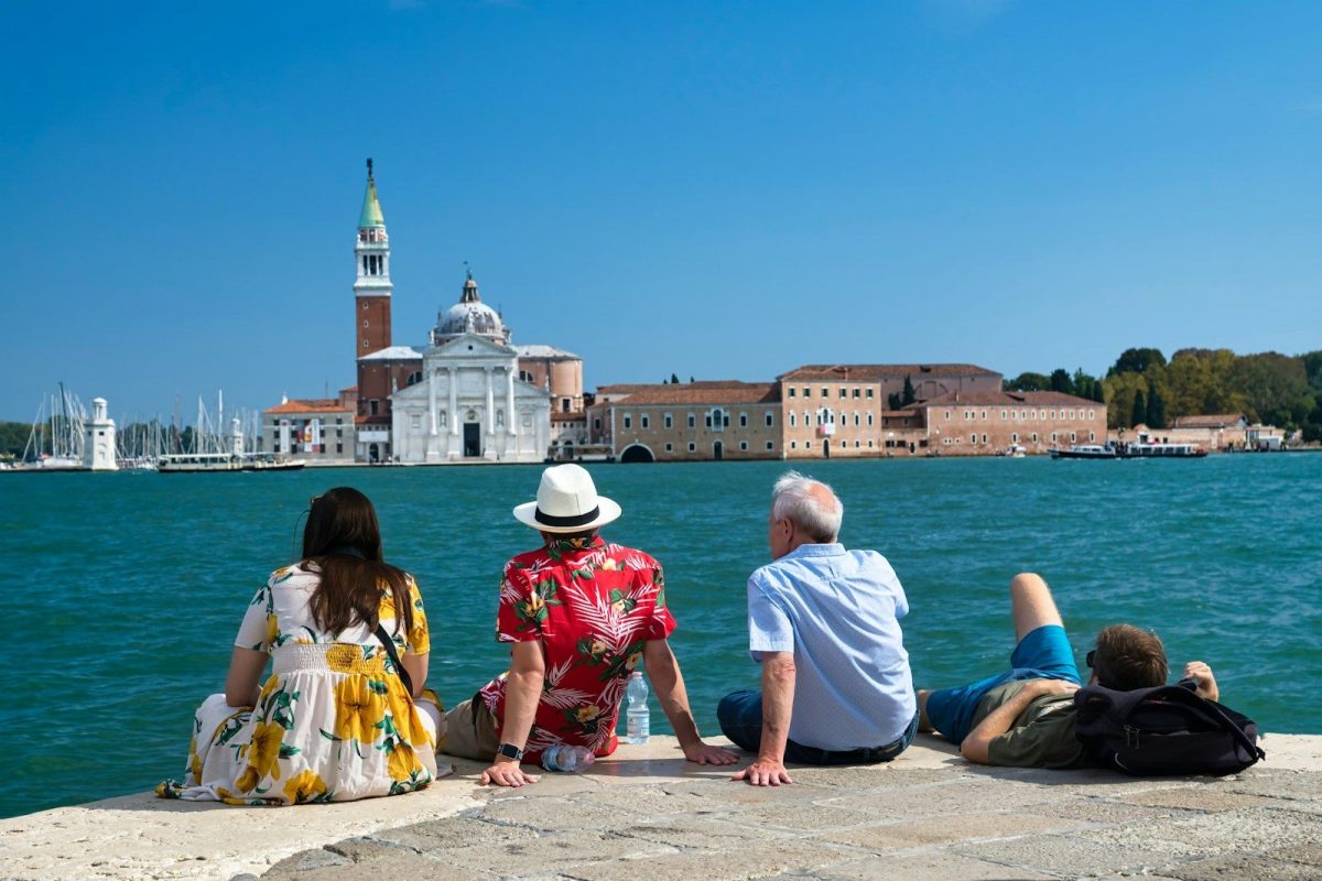 9 Behaviors Locals Hate About Tourists 9 man and woman sitting on beach shore during daytime