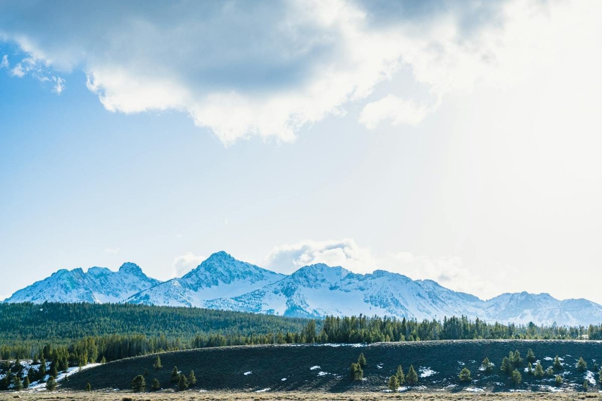 Scenic view of the snow-capped Sawtooth Mountains in Stanley, Idaho under a bright sky.