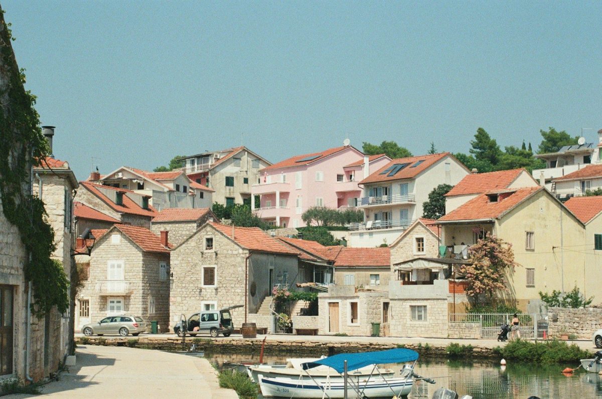 a row of houses next to a body of water