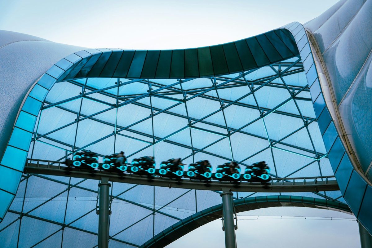 a building with a glass roof and a train on the track
