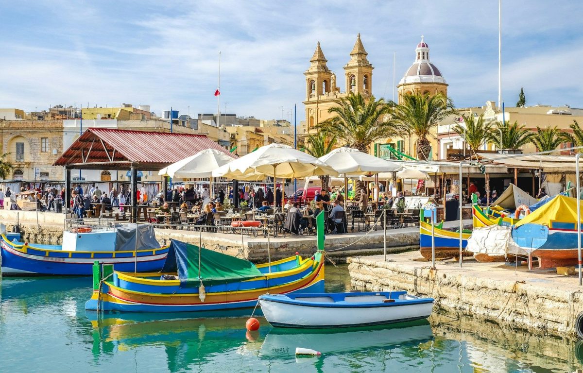 15 Great Places Around the World to Enjoy Retirement 1 blue and yellow boat on water near brown concrete building during daytime